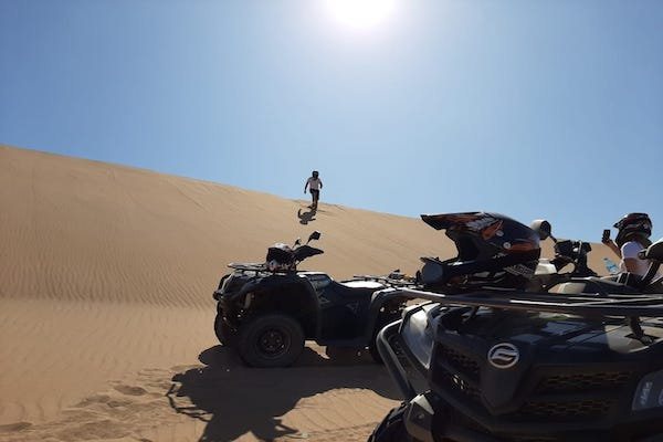 Quads parked below a Tifnit dune