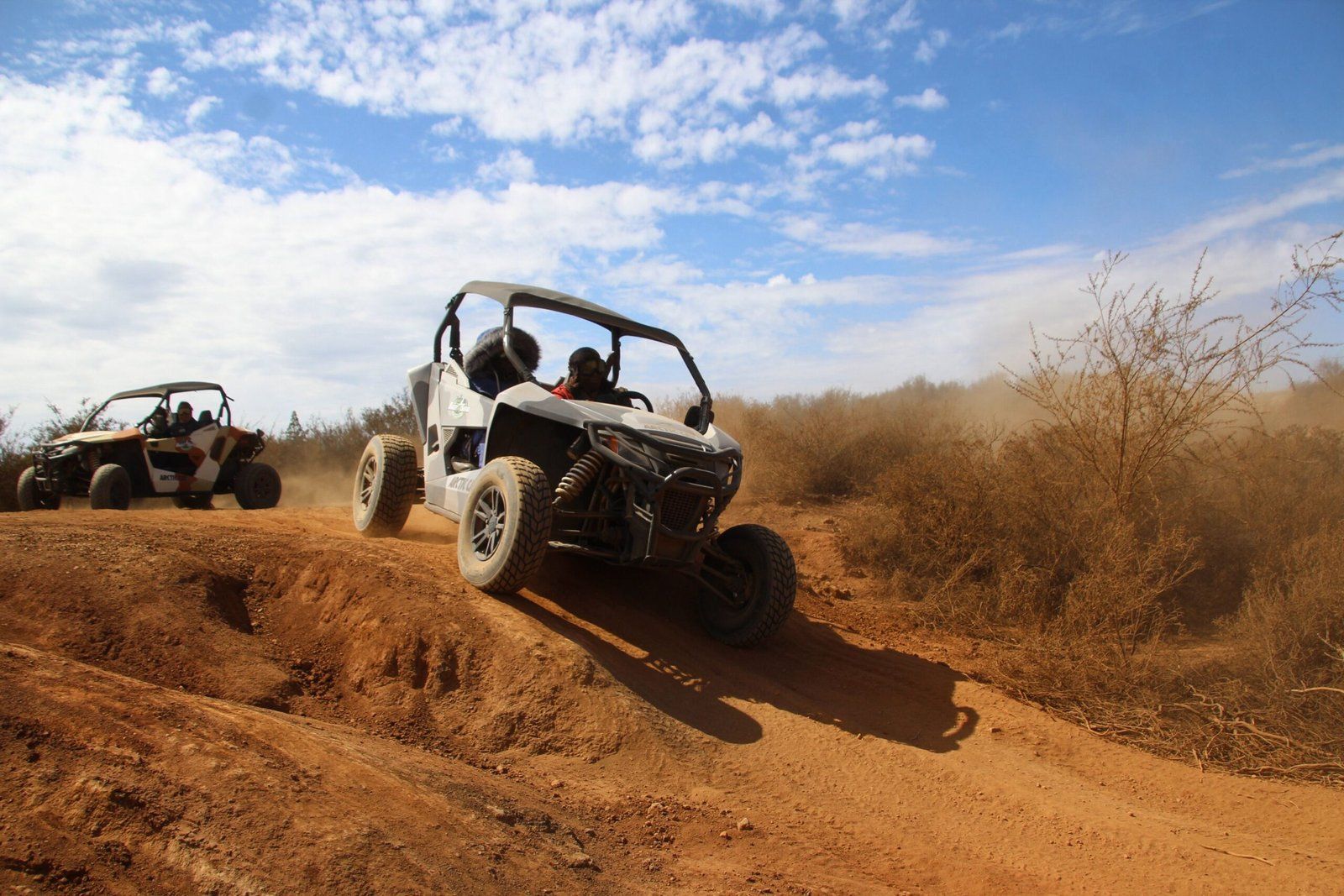 Buggy cresting a red dirt track south of Agadir with a second buggy behind
